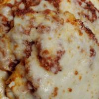 Triple Layer Lasagna · Three layers of wavy lasagna stuffed with ricotta, mozzarella, parmesan & romano cheese. The...