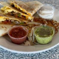 Breakfast Quesadilla · Flour tortilla stuffed with scrambled eggs, bacon and sausage, bell pepper, onion, tomato, c...