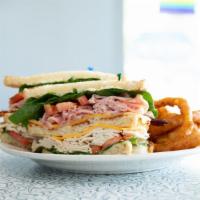 Club House · A triple decker club piled high with turkey, ham, bacon, American and Swiss cheeses with may...