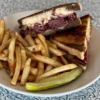 Traditional Reuben · Grilled rye piled high with fresh roasted corned beef with swiss, sauerkraut and thousand is...