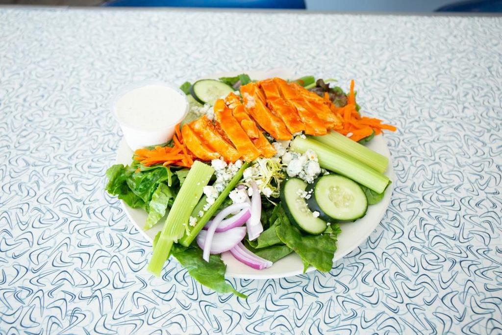 Buffalo Chicken Salad · Fresh romaine and spring mix greens, shredded carrots, cucumber, red onion, tomato and blue cheese crumbles topped with a diced chicken breast, tossed in buffalo sauce.