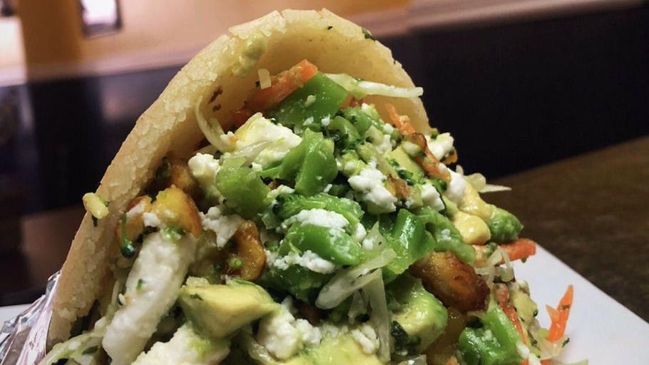 Vegetarian Arepa · Gluten free corn patty stuffed with shredded cabbage, shredded carrots, broccoli, avocado, sweet plantains, and feta cheese.