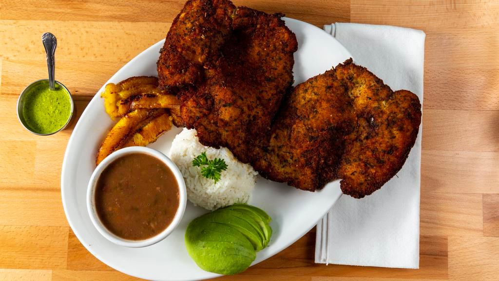 Chuleta De Pollo (Milanesa) · Breaded chicken breast served with rice, beans, sweet plantains, choice of salad or avocado.
