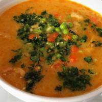 Mondongo · Soup made with pork, tripe, chorizo, potatoes, peas, and carrots. Served with rice & avocado...