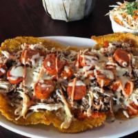 Super Patacon Con Todo · Large green plantain topped with shredded chicken, shredded beef, chorizo, creole sauce and ...