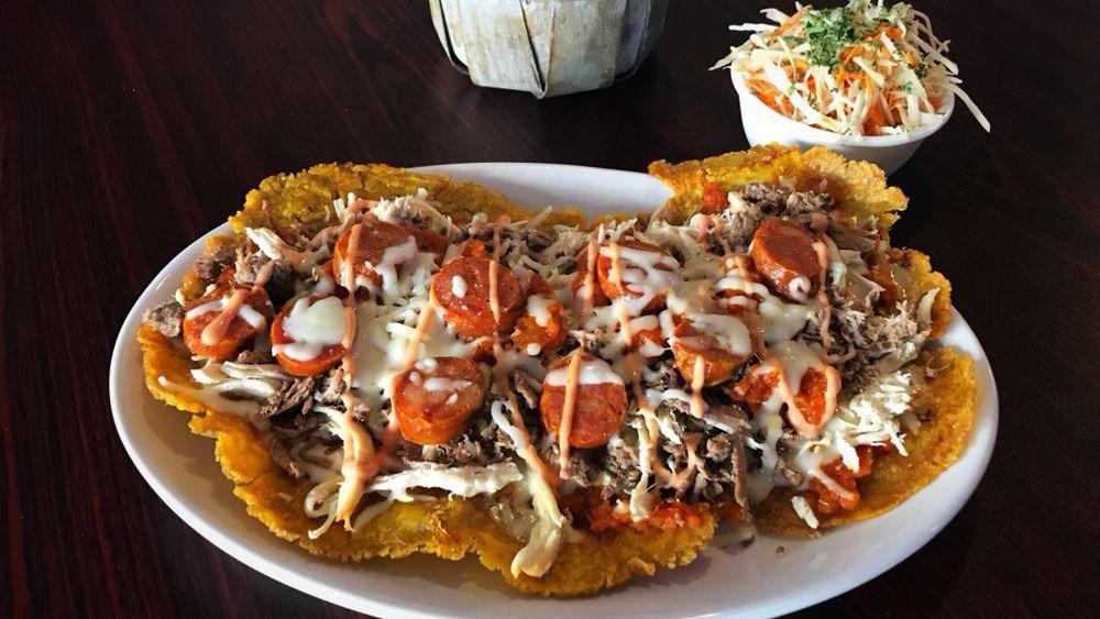 Super Patacon Con Todo · Large green plantain topped with shredded chicken, shredded beef, chorizo, creole sauce and cheese. Salad or Avocado.