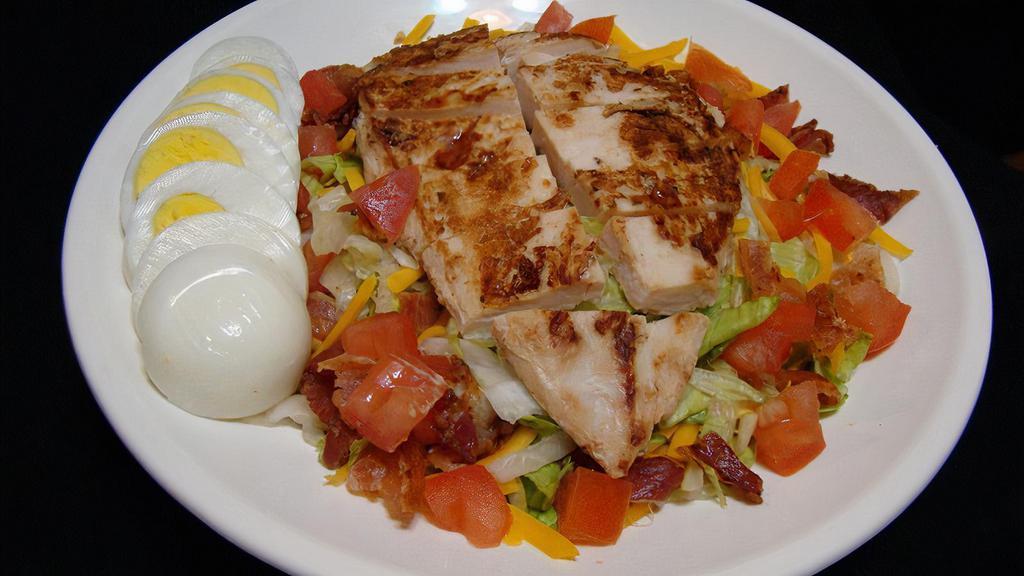 Grilled Chicken Salad · Marinated grilled chicken, bacon, cheese, tomatoes, egg, and dressing.