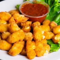 Cheese Curds · Aged Wisconsin white cheddar cheese, breaded and fried to perfection, served with marinara s...
