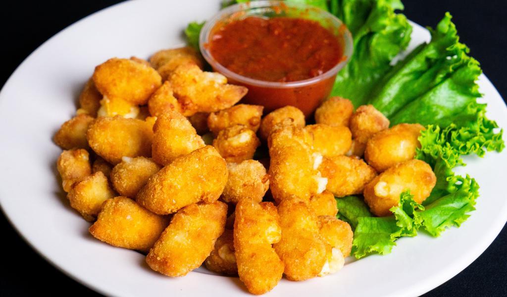 Cheese Curds · Aged Wisconsin white cheddar cheese, breaded and fried to perfection, served with marinara sauce.