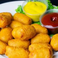 Mini Corn Dogs · Mini corn dogs double dipped and fried golden and crispy.