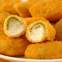 Jalapeno Poppers · Jalapenos stuffed with cream cheese, breaded, and fried to golden perfection. Served with ra...