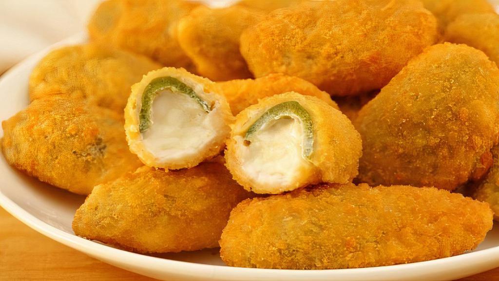 Jalapeno Poppers · Jalapenos stuffed with cream cheese, breaded, and fried to golden perfection. Served with ranch.