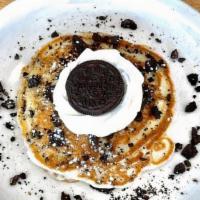 Oreo Pancakes · 3 stacked fluffy Oreo pancakes, filled with frosting & topped with whip cream and oreo crumbs.
