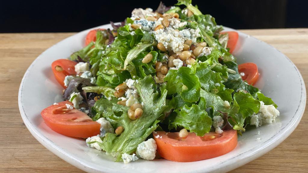 Holiday House Salad · Spring mix, tomatoes, crumbled blue cheese, pine nuts, housemade balsamic vinaigrette.
