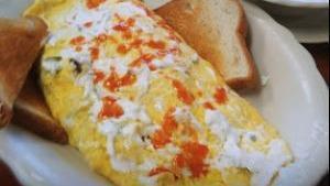 Bacon And Cheese Omelette · Prepared with three extra large eggs and served with toast and jelly and choice of hash brow...