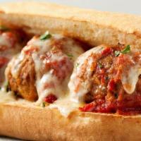 Meatball Sub · Meatballs tossed in hot pasta sauce placed in a soft sub roll, topped with freshly shredded ...