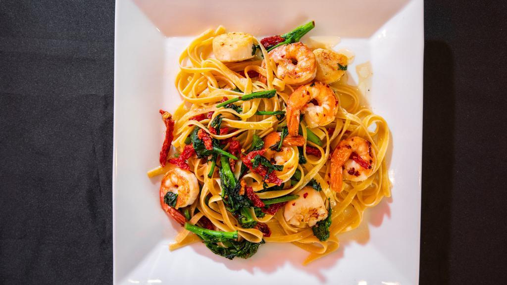 Seafood Fettuccine · Shrimp and scallops, sautéed broccoli rabe and sun dried tomatoes, white wine and butter.