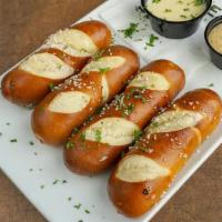 Pretzel Sticks · Four hot and chewy pretzels served with housemade queso and bavarian mustard