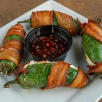 Jalapeño Poppers · Jalapeños wrapped in bacon, stuffed with mozzarella and cream cheese & served with spicy jam