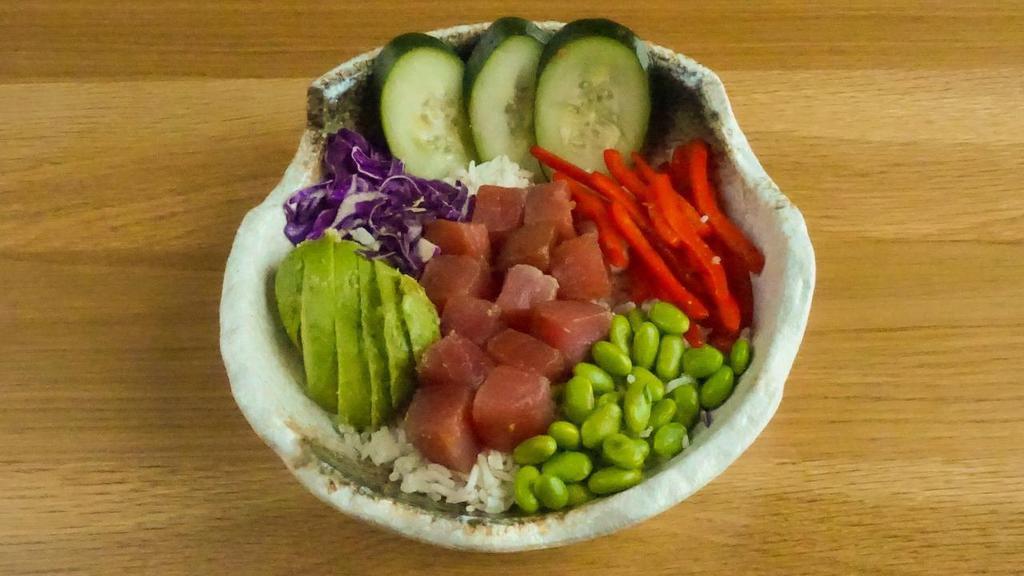 Traditional Ahi Poke Bowl · Sushi grade ahi tuna* marinated in a lemongrass soy ginger glaze, avocado, bell peppers, cucumber, red cabbage, and edamame on coconut rice
