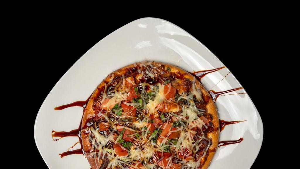 Margherita Pizza · Quarter sections topped with house-made sauce, Mozzerella cheese, basil and fresh tomato.