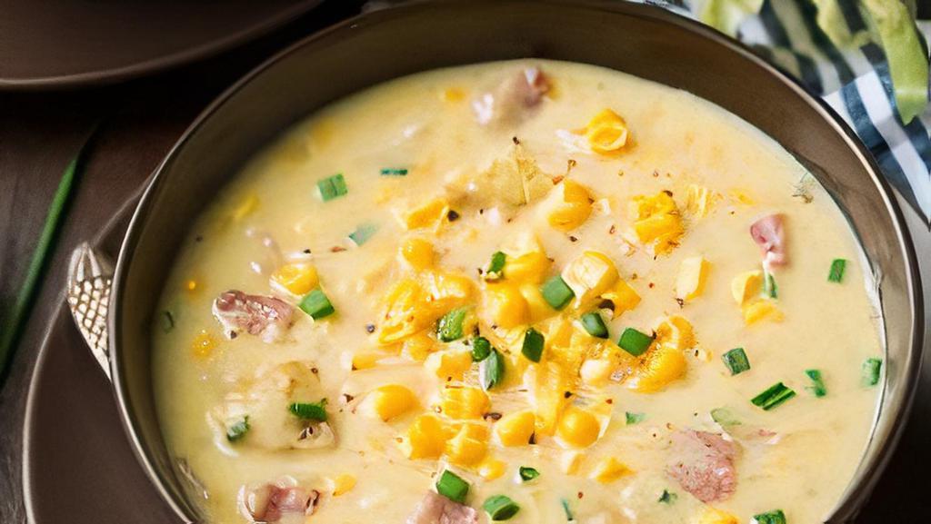 Corn Chowder · Vegetarian-friendly. Hearty roasted corn, potatoes, veggies, and cream, seasoned with our signature spices and served with a warm roll.