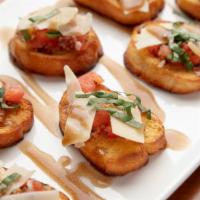 Bruschetta · Grilled baguette topped with bruschetta tomatoes, balsamic reduction, roasted garlic.