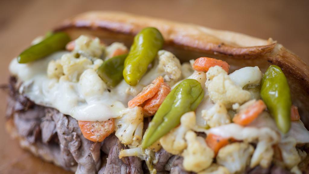 Hot Italian Beef · Thin sliced Roasted Beef in our house au-jus, Giardiniera, melty Provolone Cheese served on a Soft Roll