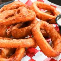 Onion Rings · 3/4 pound of thick, beer-battered sweet Spanish onions fried golden brown, served with secre...