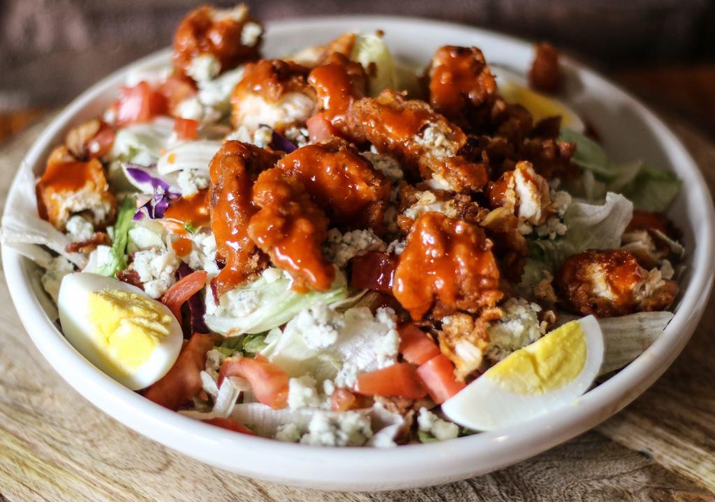 Fried Buffalo Chicken Salad · Chopped buffalo chicken, smoked bacon, egg, tomato, crumbled bleu cheese and romaine lettuce with bleu cheese dressing.