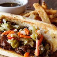 The Italian Beef · A classic prep of seared beef, giardiniera and au jus on a French roll-order it dry or wet.