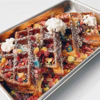 Rainbow Magic Waffle · Fruity pebbles, fresh strawberry, chocolate drizzle,  powdered sugar and whipped cream.