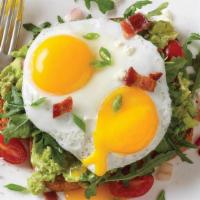 Avocado Toast* · Smashed avocado, arugula and grape tomato salad on wheat toast, topped with two eggs (any st...