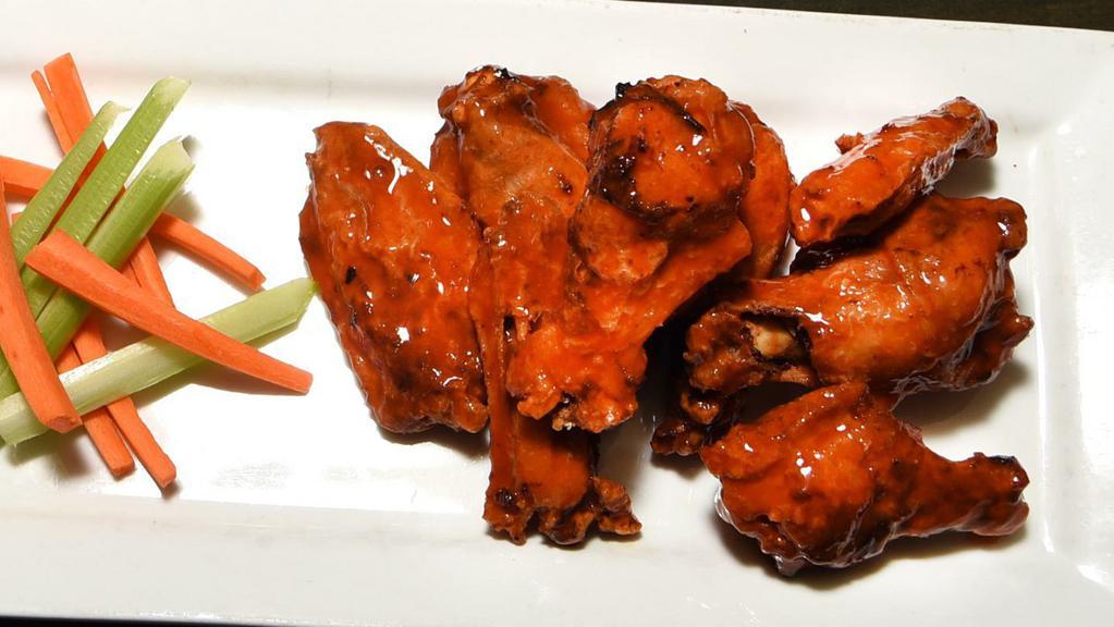 Urban Wings · Buffalo, Caribbean jerk, sesame soy or Parmesan garlic, served with carrots, celery, and blue cheese.