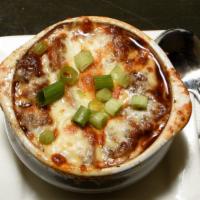 French Onion Soup · Caramelized onions, crostini, Swiss, and Parmesan crust.