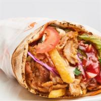 Chicken Shawarma Pita Sandwich · Garlic, chicken shawarma, pickles and fresh tomatoes stuffed artfully into a delicious pita ...