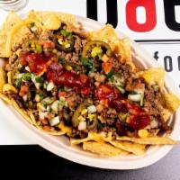 Nachos · Tortilla chips piled high and layered with red beans and our ground beef, jalapeños and pico...