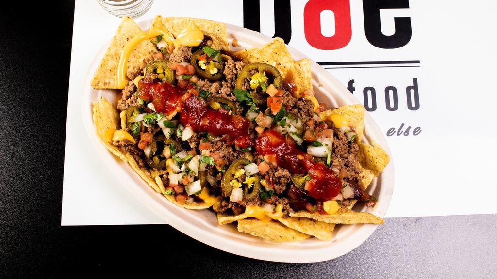 Nachos · Tortilla chips piled high and layered with red beans and our ground beef, jalapeños and pico de gallo.