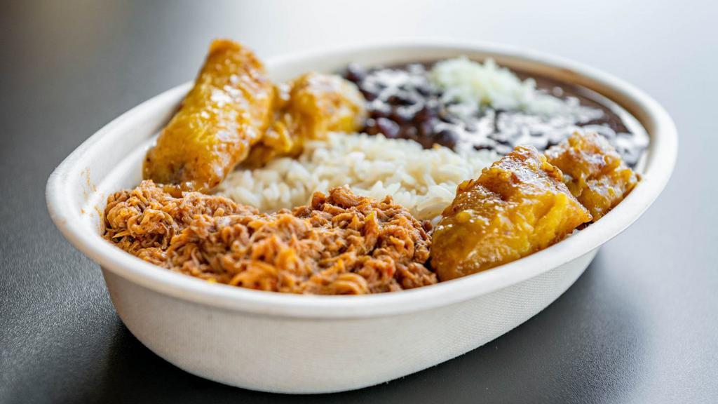The Venezuelan Beef · Traditional Venezuelan dish (Pabellón Criollo) with white rice, black beans, fried sweet plantains and shredded beef.