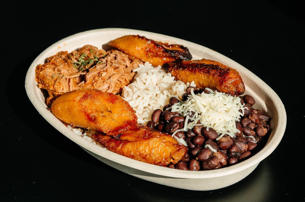 The Venezuelan Chicken · Traditional Venezuelan dish (Pabellón Criollo) with white rice, black beans, fried sweet plantains and shredded chicken.