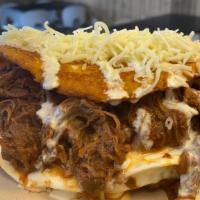 Beef Cachapa · Ours corn pancakes with 1/2 wheel of fresh soft white  cheese, shredded beef, cream and grat...