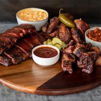 Signature Sampler For 4 People · Pork Spare Ribs, Beef Burnt Ends, Fire-Kissed Wings, Hickory Pit Beans, Cheesy Corn Bake, Br...