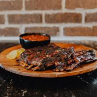 Lamb Ribs Dinner · Full slab of our nationally-acclaimed Denver-cut ribs. Includes one side.