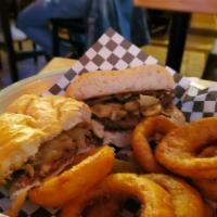 Tenderloin Sandwich · 6 oz. tenderloin steak with sautéed mushrooms and onions, served on torpedo bread.