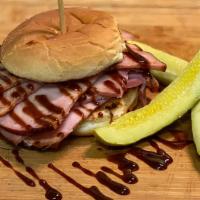 The Mad Hatter · 1/2 pound of smoked ham piled on a toasted bun topped with our house BBQ sauce. Served with ...