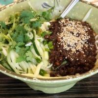 Peking Zha Jiang Noodle · Ramen style noodles topped with a sauce made of ground pork, black beans, and onion. Garnish...