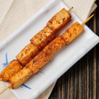 Fish Tofu · Grilled fish tofu cakes on a skewer glazed with bbq sauce and sprinkled with cumin, chili, a...