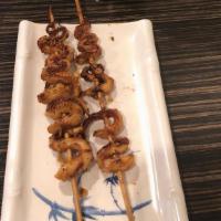 Squid Feet · Grilled squid tentacles on a skewer glazed with bbq sauce and sprinkled with cumin, chili, a...