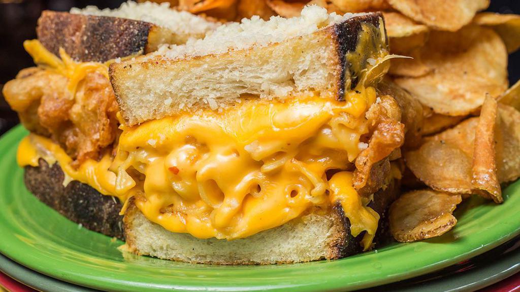Mighty Macaroni · Creamy homemade macaroni and cheese battered and deep fried, layered with Cheddar cheese sauce and your favorite melted cheese.