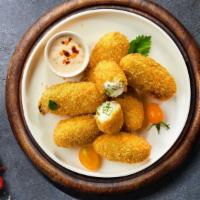 Spicy Poppers · (Vegetarian) Fresh jalapenos coated in cream cheese and fried until golden brown. Served wit...